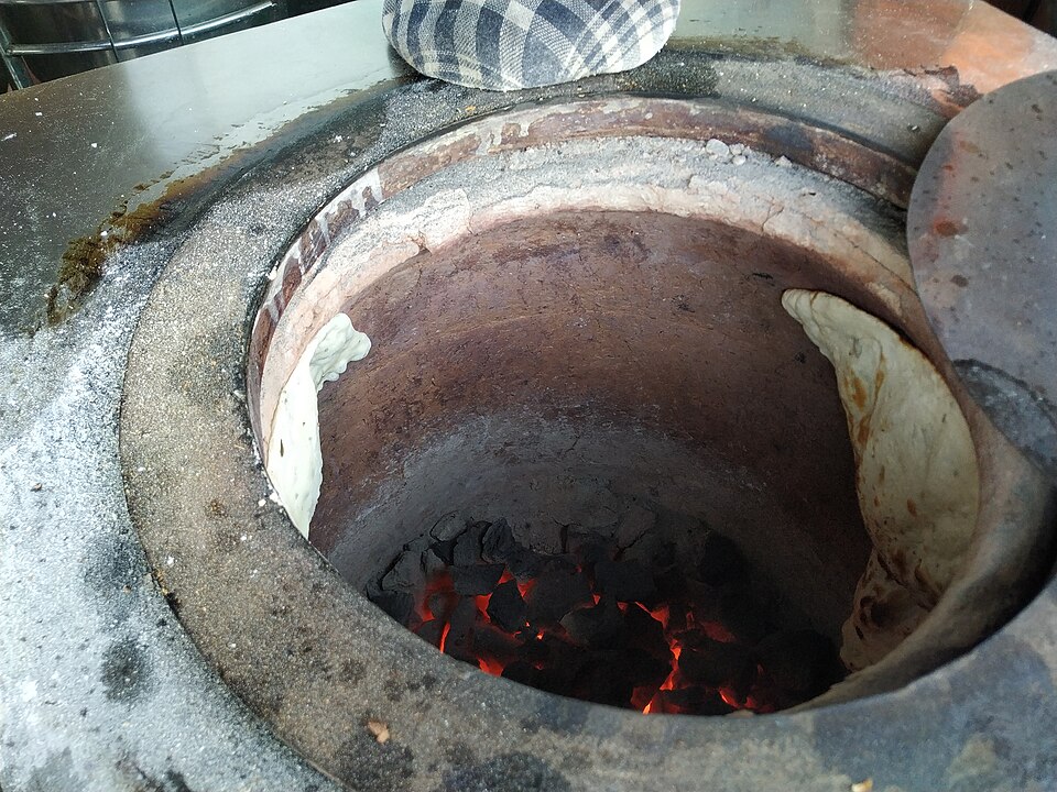 Naan baking inside the tandoor